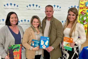 Volunteers holding books