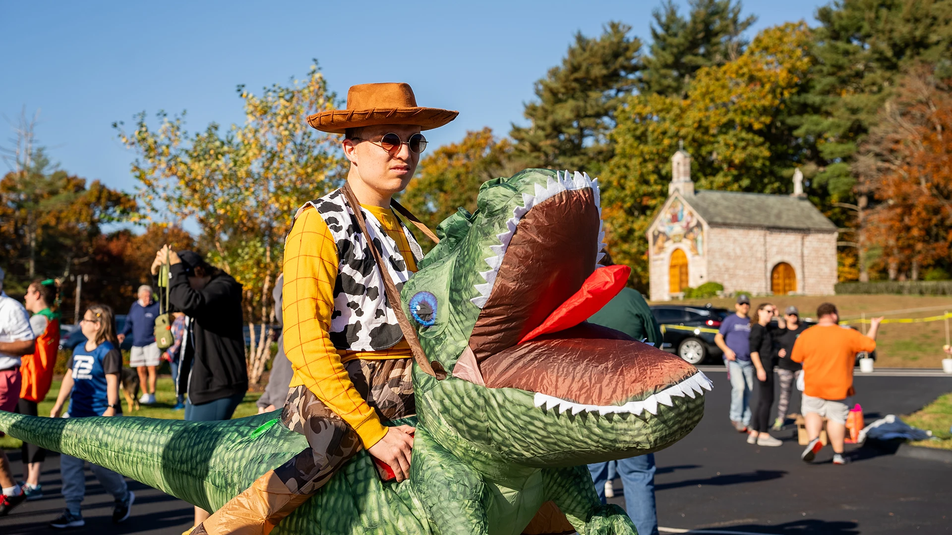 Staging for the fun run - student wearing a Dino costume.