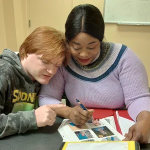 Cushing adult and teacher working together