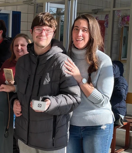 Teacher Allison Miller, student Jonathan Perrault and teaching assistant Julia Douglas take out the cart.