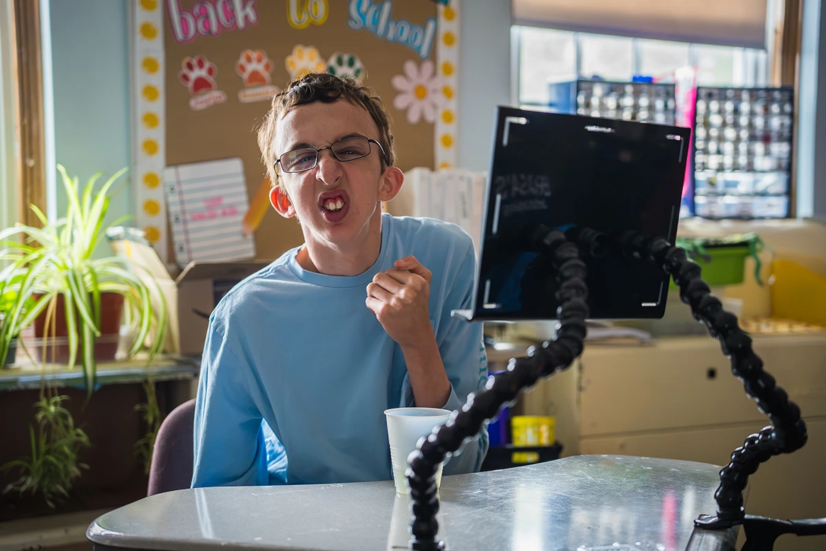 Happy Cushing student on computer giving first pump