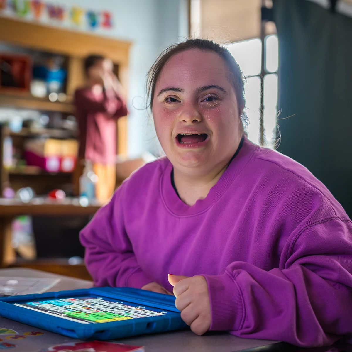 Happy Cushing student working on tablet