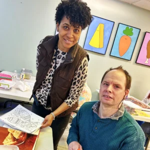 Teacher and Cushing adult smiling for camera