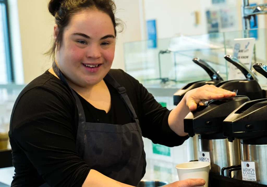 Cafe worker pouring coffee